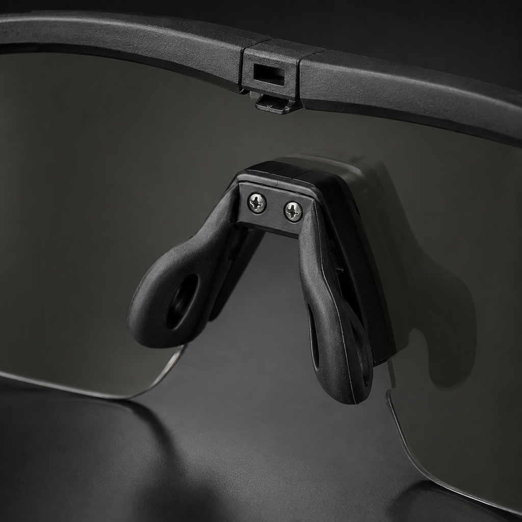 Close-up of tactical goggles adjustable nose pad, black frame, transparent lenses, showing anti-slip design, protective eyewear for outdoor and CS.