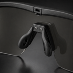 Close-up of tactical goggles adjustable nose pad, black frame, transparent lenses, showing anti-slip design, protective eyewear for outdoor and CS.