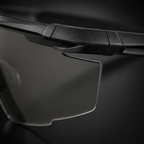 Close-up of tactical goggles lens edge, black frame, transparent lenses, precise frame-to-lens connection, adjustable nose pad, protective eyewear for CS and outdoor use.