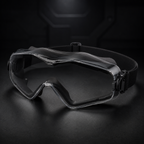 Black RETACKIT Tactical Assault Goggles Pro at 45-degree front angle, highlighting lens transparency, frame contour, nose support, and strap hardware. Sleek dark background, premium tactical eyewear for airsoft and CS games.