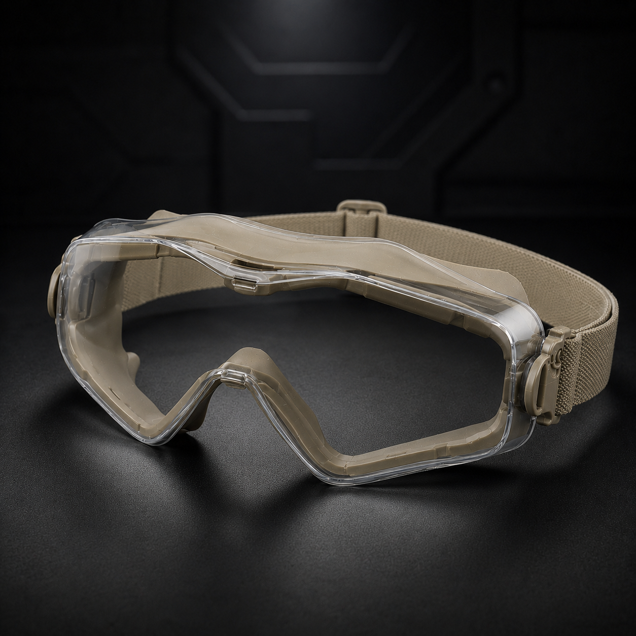 Khaki tactical goggles in 45-degree front angle, clear lens, full-wrap frame, nose bridge, and black adjustable strap. Minimalist dark background, premium ecommerce product shot for outdoor, airsoft, and tactical training.